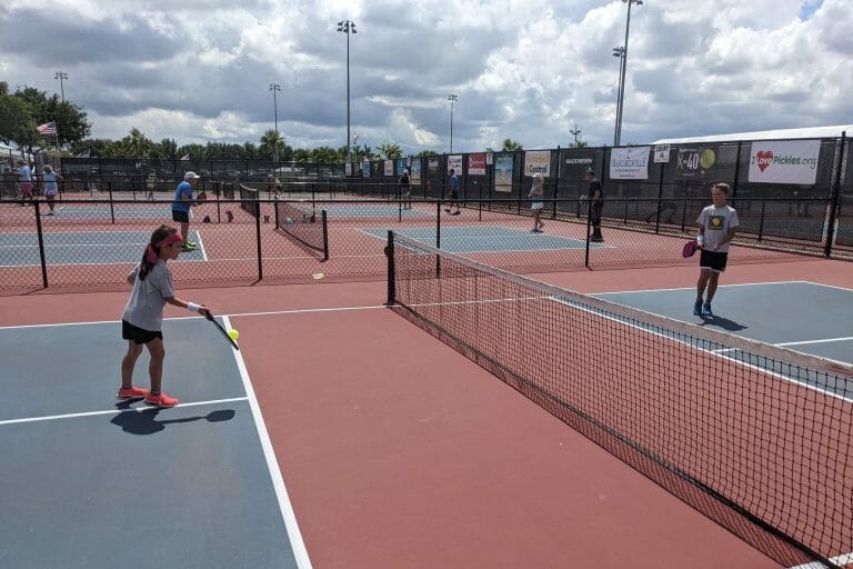 a group of people playing basketball on a court with a racket